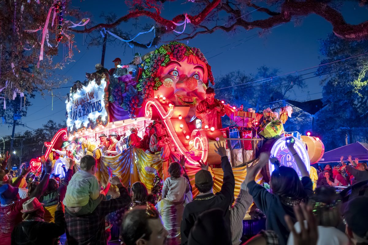 A Krewe of Bacchus float passes through a crowd during Mardi Gras in New Orleans.