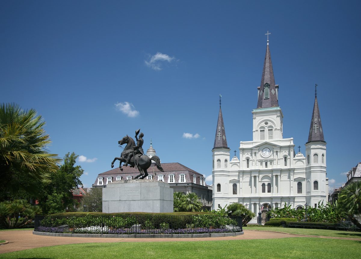 An aerial view of Jackson Square, the historic central plaza of the French Quarter, with St. Louis Cathedral in the background.